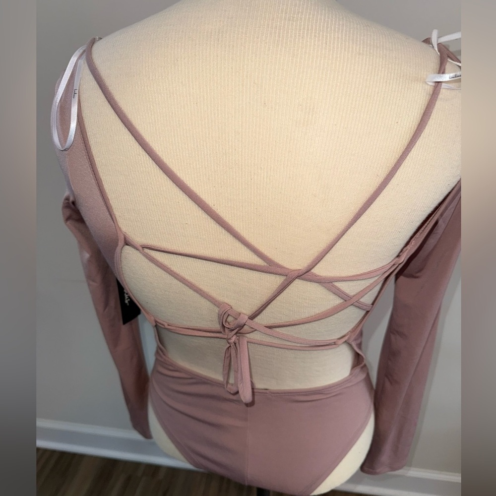 Nude strappy bodysuit.